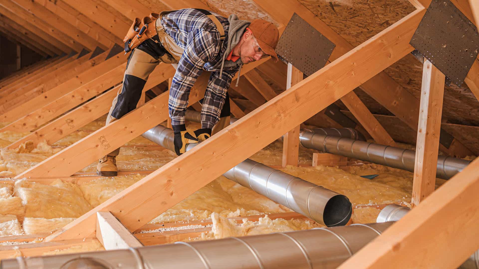 hvac-specialist-installing-new-air-duct-system-in-residential-attic