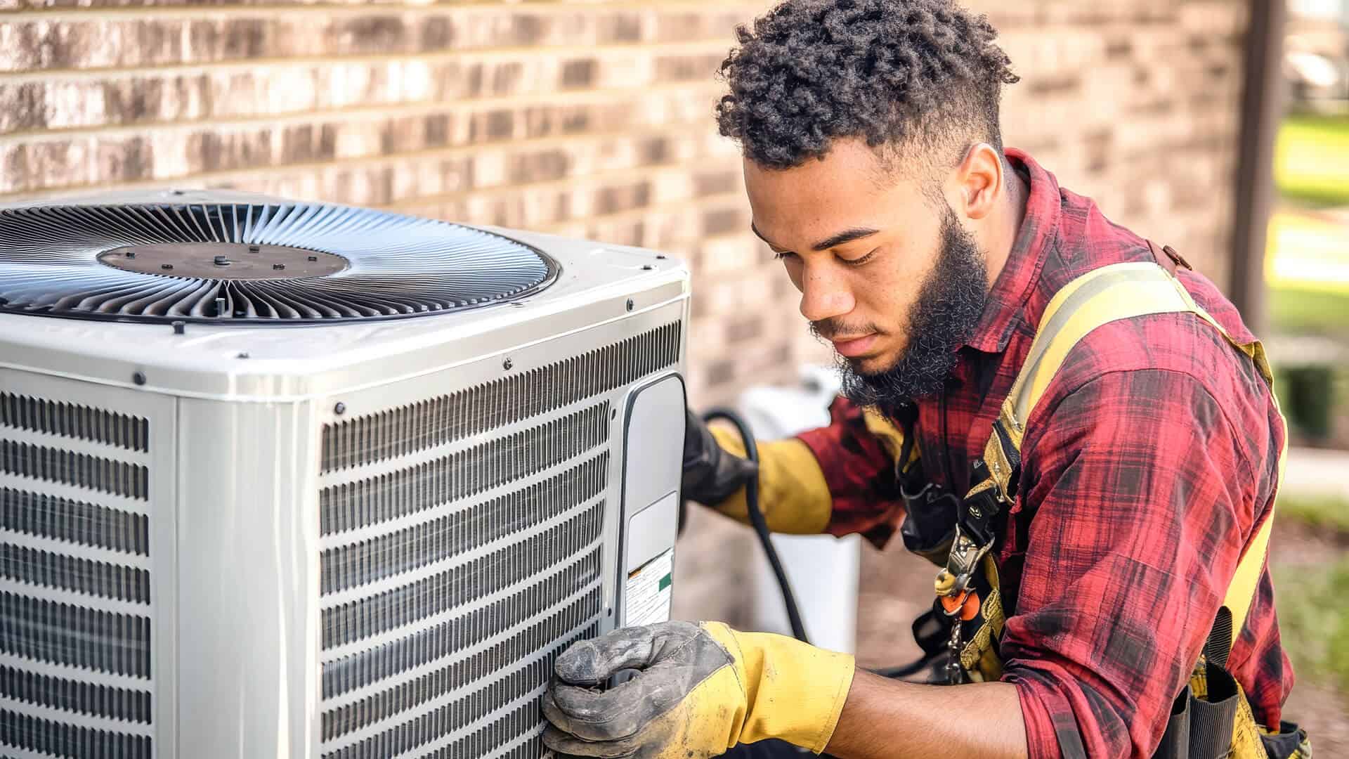 hvac-tech-installing-ac-unit