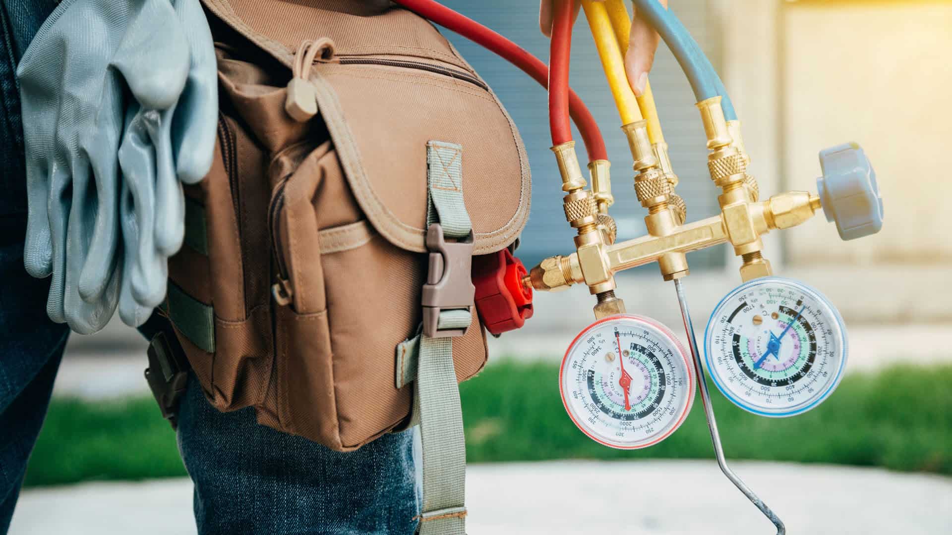 hvac-technician-holding-ac-gauges